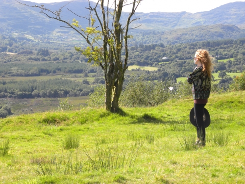Author Vivian Schilling overlooks the Bonane Valley from atop a fairy fort in County Kerry, Ireland.           